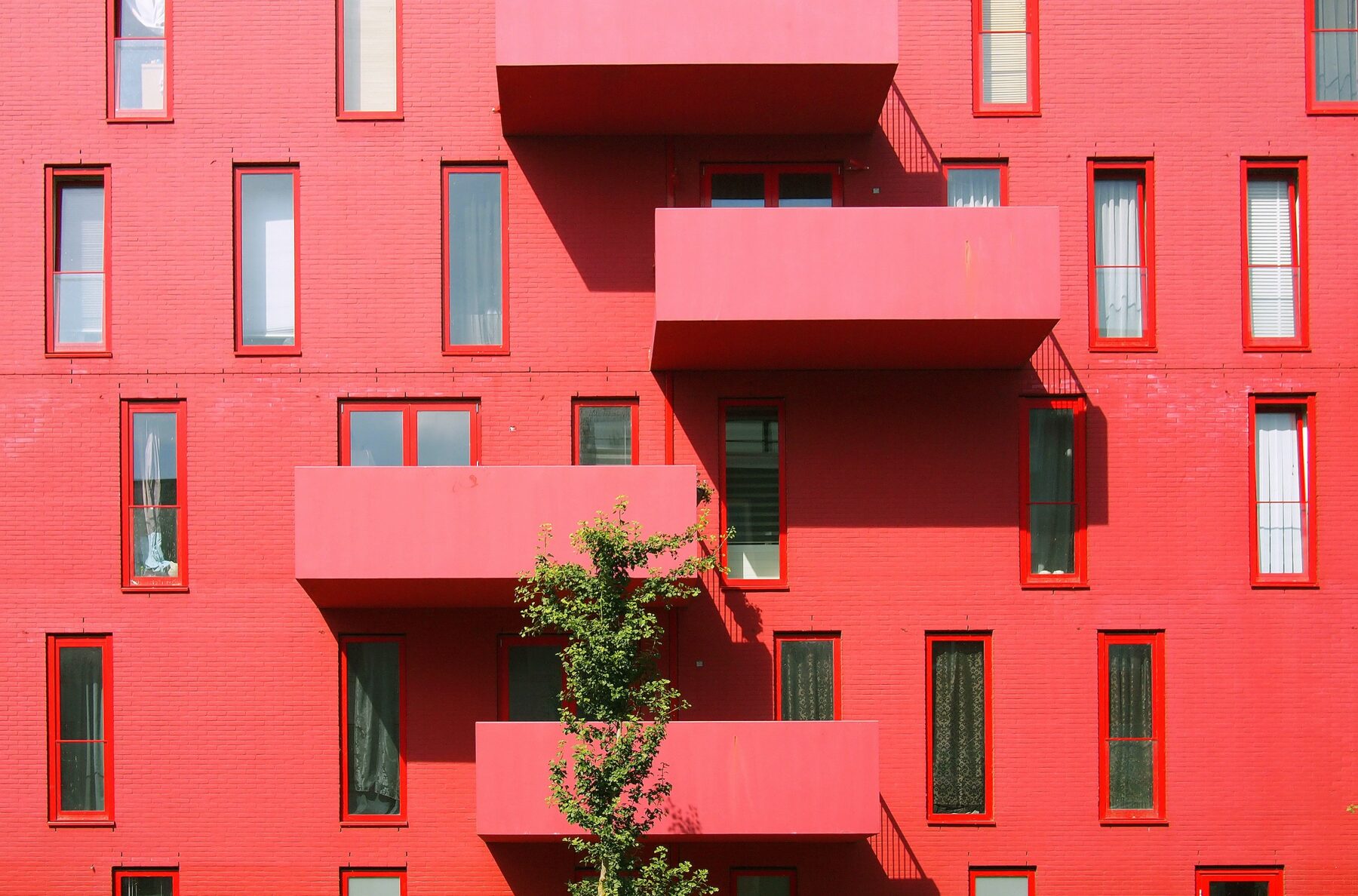 front facade of red-pink building balconies-types of liens article