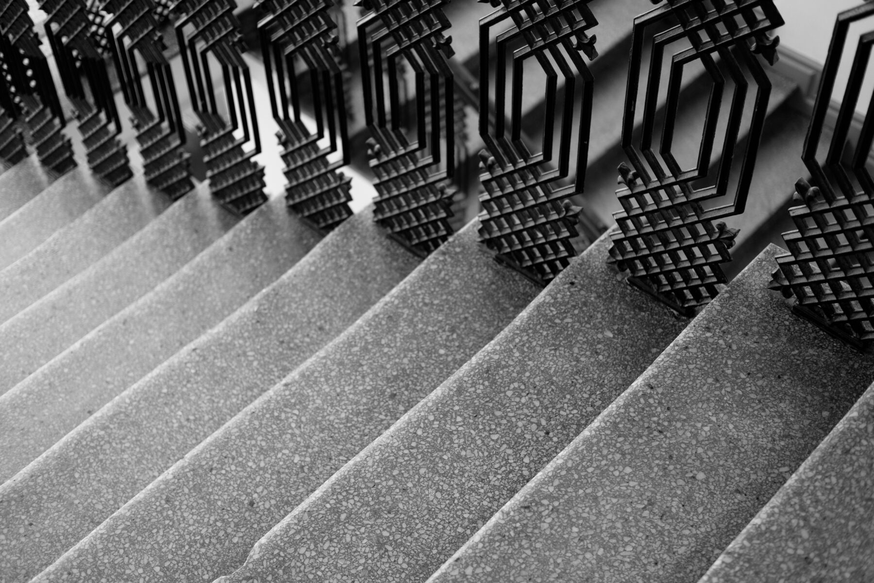 gray stairs with black wrought iron decorative railings- types of liens article