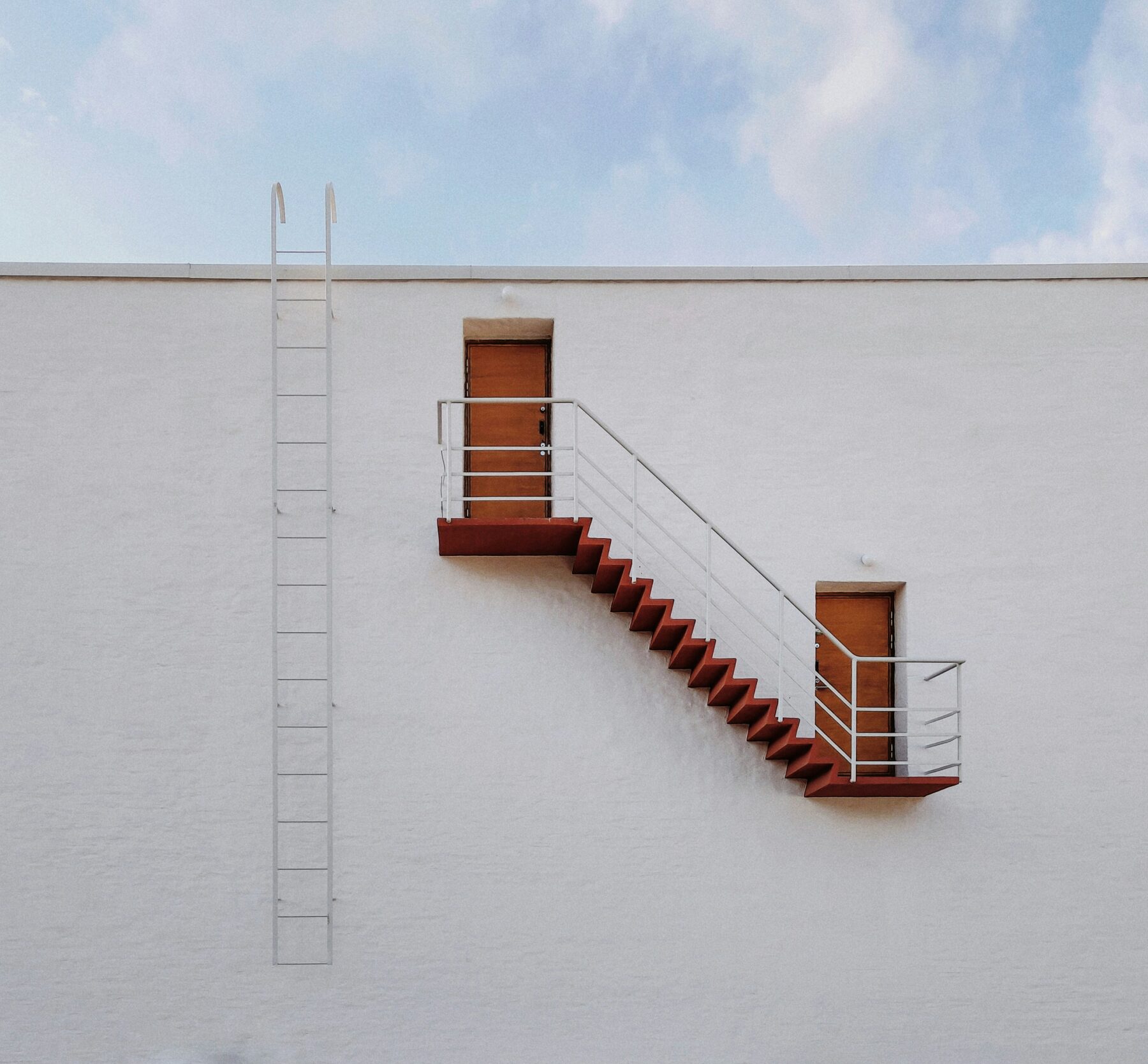 white building roof and orange escape stairs- types of liens article