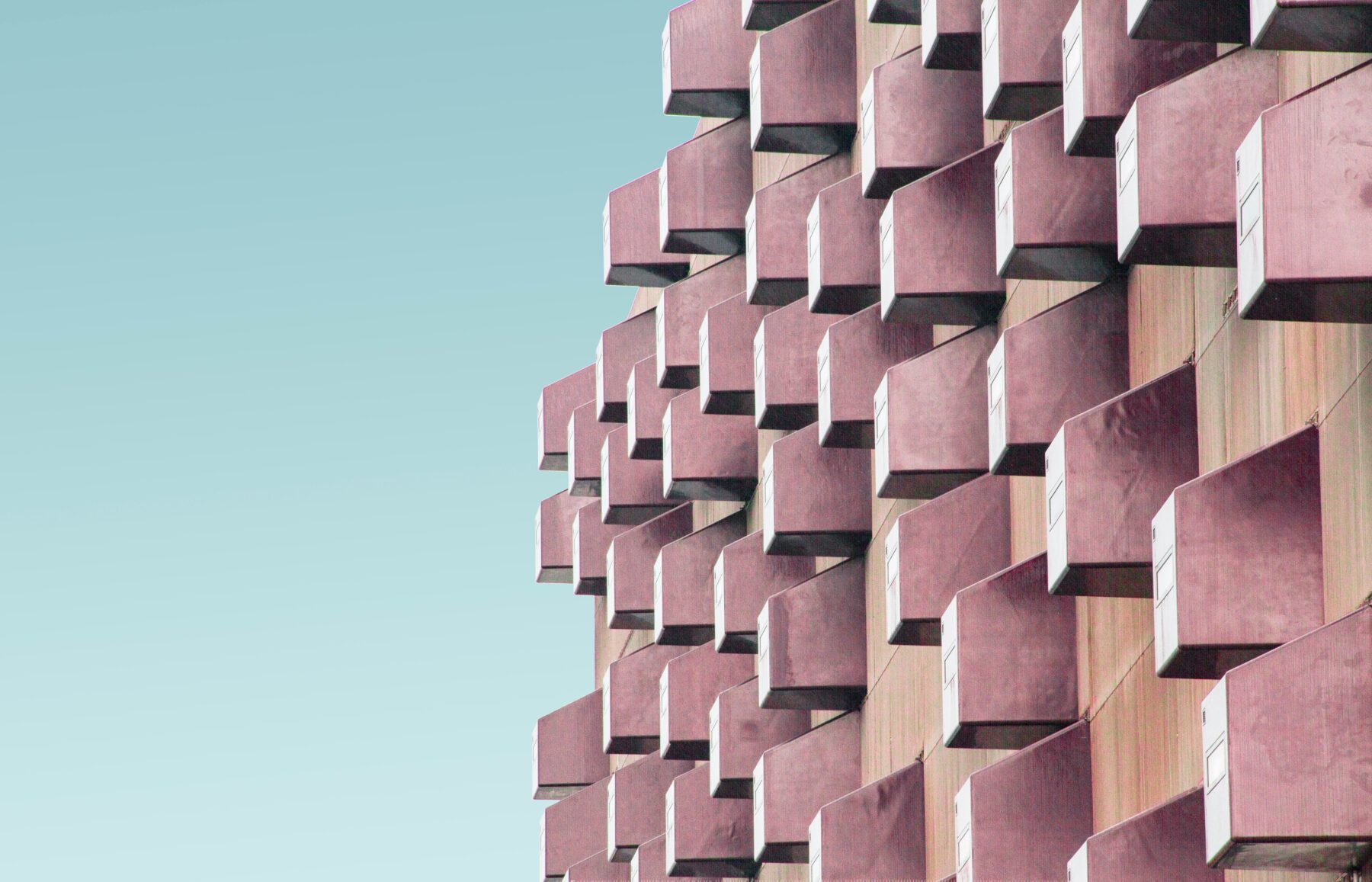 pink blocks on a building on blue gradient font-types of liens article