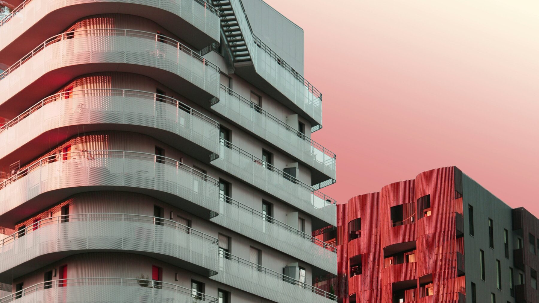 single family vs multi-family  condo buildings pink hue background