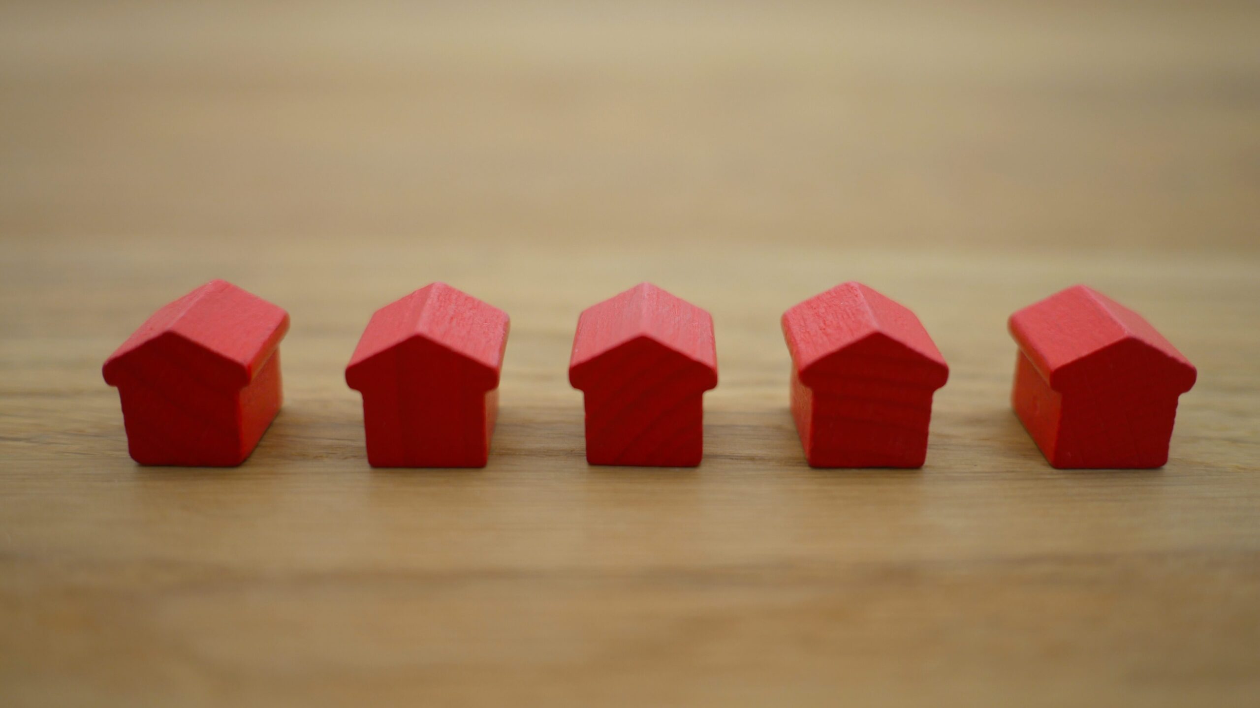 5 red houses on a wooden table mortgage payoff