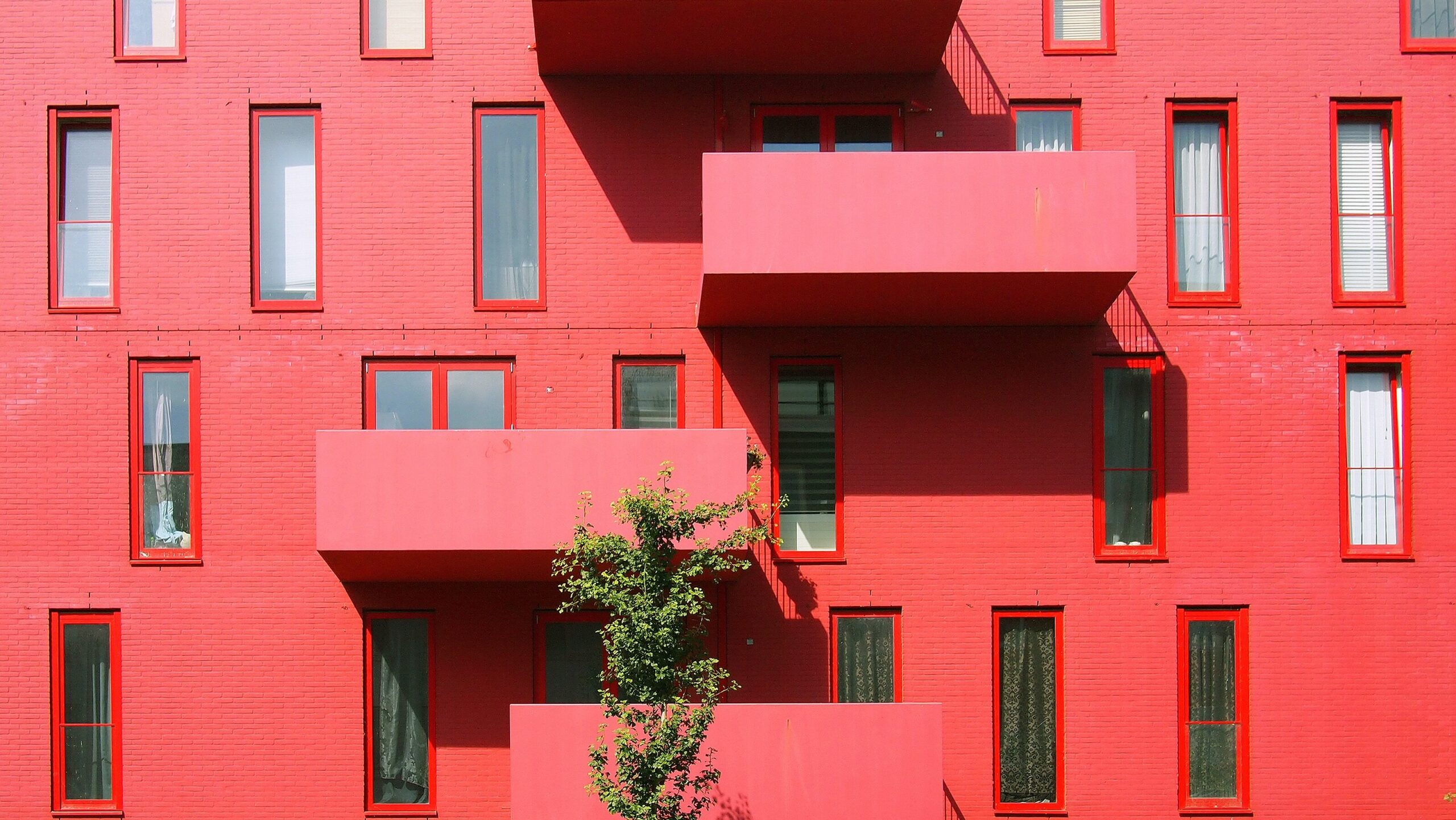 ai in property management front facade of red-pink building balconies-types of liens article