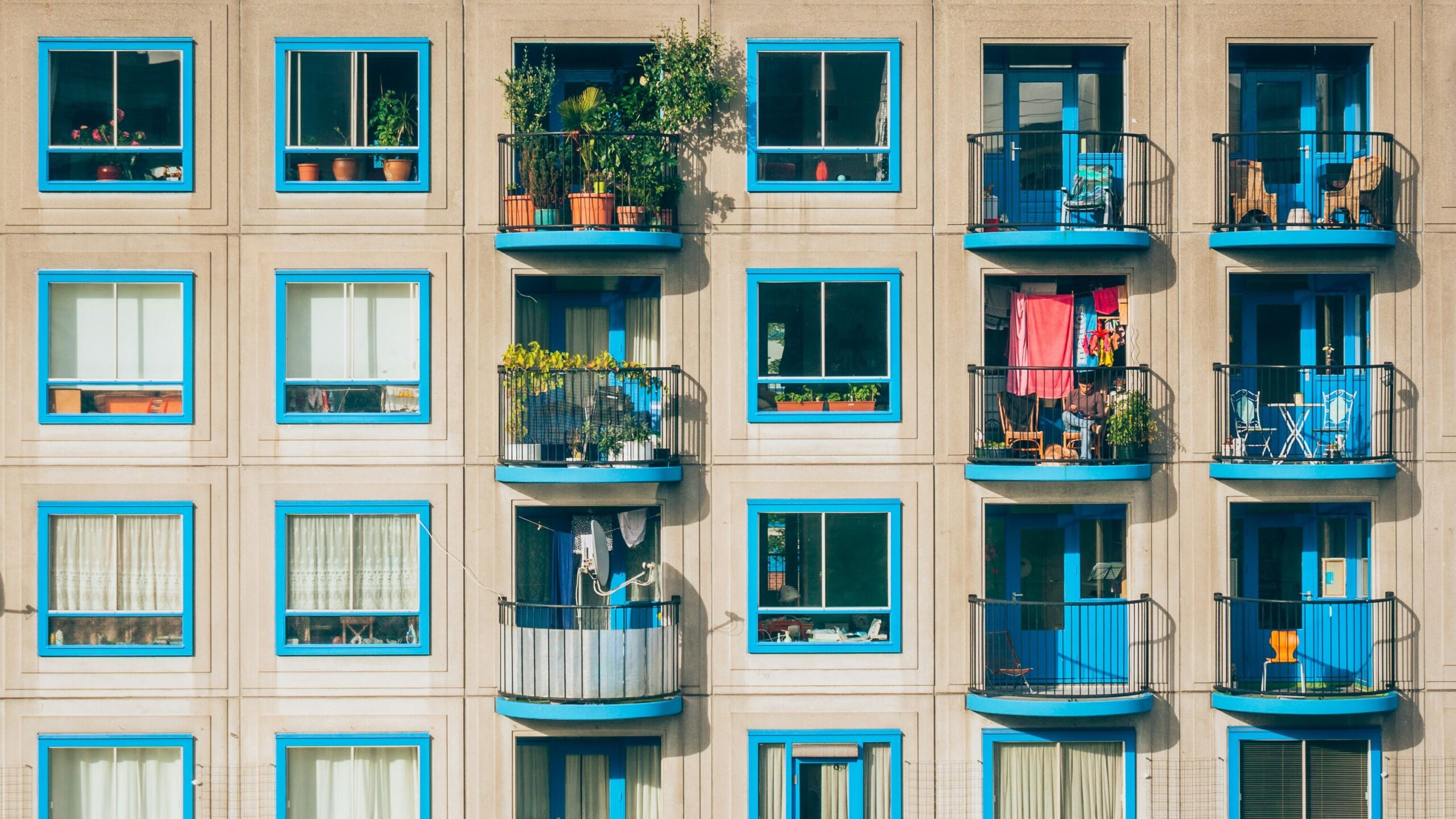 ai in property management beige facade building with baby blue window trims and balconies with plants-types of liens article